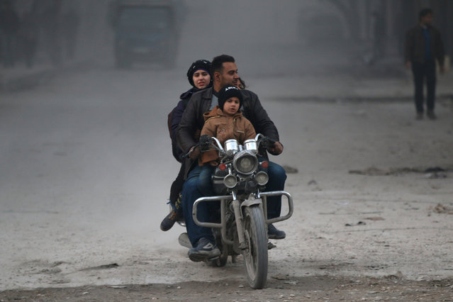 Civilians on a motorbike flee deeper into the remaining rebel-held areas of Aleppo, Syria December 9, 2016. (Photo by Abdalrhman Ismail/Reuters)