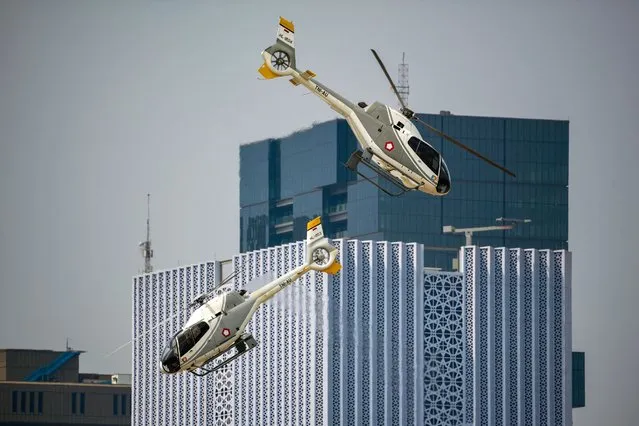 Indonesian Air Force EC120B Colibri helicopters perform aerial maneuvers during a rehearsal for the 78th anniversary of the Indonesian military in Jakarta on October 3, 2023. (Photo by Bay Ismoyo/AFP Photo)