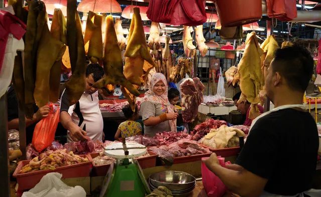 In this Thursday, November 1, 2018, photo, a woman buys freshly butchered meat in Kampung Baru, Malaysia. A United Nations report says some 486 million people are malnourished in Asia and the Pacific, and progress in alleviating hunger is stalling. (Photo by Yam G-Jun/AP Photo)