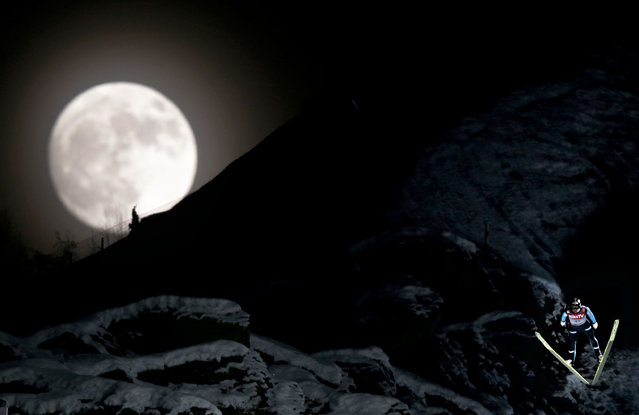 Norway's Anders Bardal jumps during the official training session of the FIS Ski Flying World Cup in Vikersund, Norway on January 25, 2013,  while a full moon rises over the mountain. (Photo by Daniel Sannum Lauten/AFP Photo)