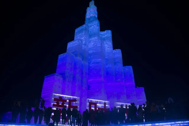 Tourists visit illuminated ice sculptures at Ice and Snow World park on January 5, 2019 in Harbin, China. (Photo by Tao Zhang/Getty Images)