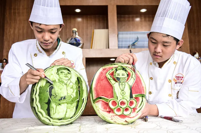  Students carve portraits of gold medalists Li Fabin and Yang Qian on watermelons at Shenyang Foreign Affairs Service School on day five of the Tokyo 2020 Olympic Games on July 28, 2021 in Shenyang, Liaoning Province of China. (Photo by VCG/VCG via Getty Images)