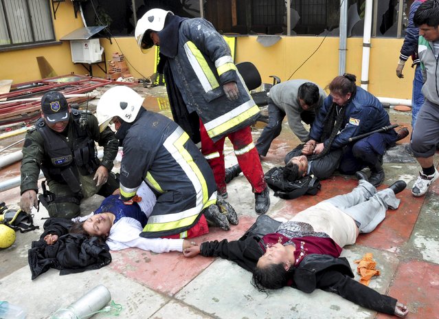 Injured municipal employees receive first aid after a group of protesters occupied and set fire to municipal offices in El Alto, on the outskirts of La Paz, February 17, 2016. Tensions are high in the country ahead of a national referendum on Sunday which will ask Bolivians if they wish to alter the constitution to allow President Evo Morales to run for a fourth term. (Photo by Reuters/APG agency)