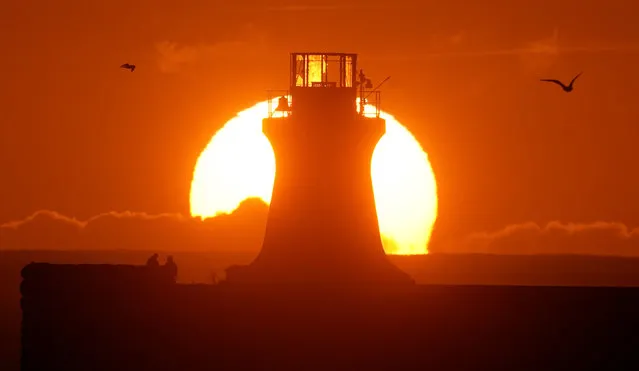 The sun rises over South Shields lighthouse on Sunday October 22, 2023, after the top was ripped off, following Storm Babet which battered the UK, causing widespread flooding and high winds. The Environment Agency has warned that flooding from major rivers could continue until Tuesday, amid widespread disruption caused by Storm Babet which is posing a “risk to life” in some areas. (Photo by Owen Humphreys/PA Images via Getty Images)