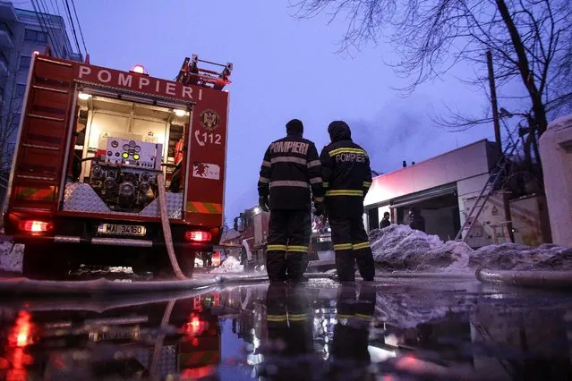 Romanian firefighters work at the scene of a fire that destroyed a night club in Bucharest, Romania, January 21, 2017. (Photo by Octav Ganea/Reuters/Inquam Photos)