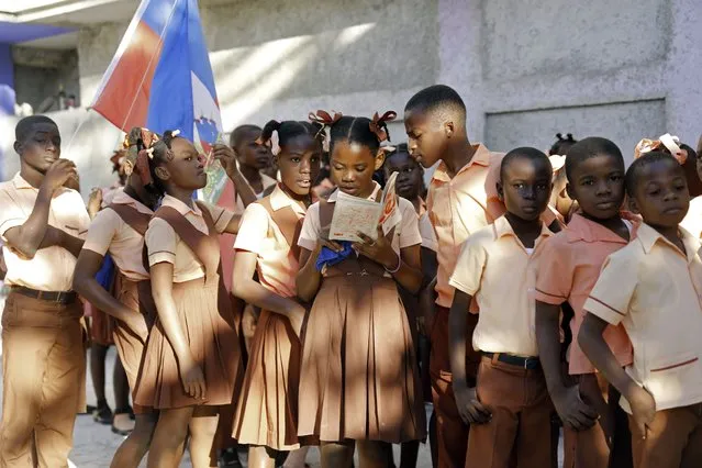 Students from the private school Gabriel stand in line as they prepare to start their school day in Port-au-Prince, Haiti, Tuesday, January 9, 2024. (Photo by Odelyn Joseph/AP Photo)