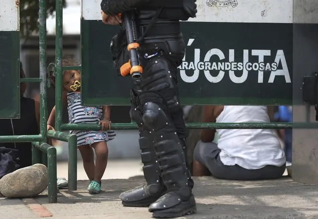 A Venezuelan child stands at a checkpoint near the Simon Bolivar International Bridge in La Parada, Colombia, Wednesday, February 27, 2019, on the border with Venezuela whose government closed the bridge to block aid from entering. U.S. envoy Elliott Abrams says the Trump administration will seek a U.N. Security Council vote this week on a resolution calling for Venezuela's government to let in humanitarian aid and to hold free elections. (Photo by Martin Mejia/AP Photo)