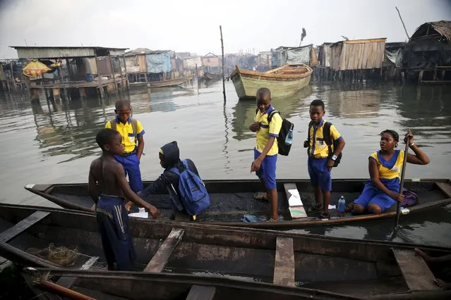 Students who attend a floating school travel on a canoe to school in the Makoko fishing community on the Lagos Lagoon, Nigeria February 29, 2016. (Photo by Akintunde Akinleye/Reuters)