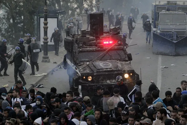 Protesters clash with police in the streets of Algiers, Algeria, during a demonstration denouncing President Abdelaziz Bouteflika's bid for a fifth term, Friday, March 1, 2019. Tens of thousands of protesters marched through Algeria's capital Friday against ailing President Abdelaziz Bouteflika's bid for a fifth term, surging past a barricade and defying repeated volleys of tear gas fired by police during the tense demonstration. (Photo by Toufik Doudou/AP Photo)