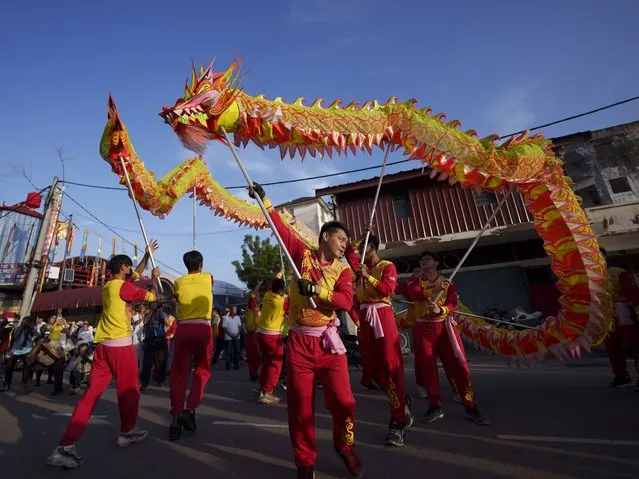 Dragon dance performance during a procession for Wangkang or “royal ship” festival at Yong Chuan Tian Temple in Malacca, Malaysia, Thursday, January 11, 2024. (Photo by Vincent Thian/AP Photo)