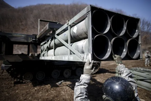 A U.S. army soldier loads rocket pods on a M270A1 multiple launch rocket system as they prepare for a live-fire training exercise of the 6-37th Field Artillery Regiment at a training area near the demilitarized zone separating the two Koreas, in Cheorwon, South Korea, March 9, 2016. (Photo by Kim Hong-Ji/Reuters)