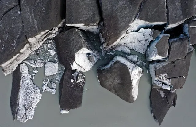 In an aerial view, broken off sections of ice from the retreating Russell Glacier rest in meltwater on September 08, 2021 near Kangerlussuaq, Greenland. 2021 will mark one of the biggest ice melt years for Greenland in recorded history. Researchers from Denmark estimated that in July of this year enough ice melted on the Greenland Ice Sheet to cover the entire state of Florida with two inches of water. According to NASA, 5 trillion tons of ice have melted in Greenland over approximately the past 15 years, enough to increase global sea level by nearly an inch. The observations come on the heels of the recent United Nations report on global warming which stated that accelerating climate change is driving an increase in extreme weather events. (Photo by Mario Tama/Getty Images)