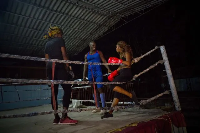In this January 24, 2017 photo, Olympic silver medalist Emilio Correa Jr., center, instructs Idamerys Moreno, right, and Legnis Cala, at a sports center in Havana, Cuba. Once when the women were kicked out a of boxing gym, Correa Jr. stepped in to help some of them find another gym while they push top Cuban officials to support female boxing. (Photo by Ramon Espinosa/AP Photo)
