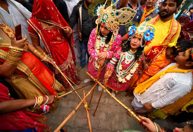 Hindu devotees are seen playing with sticks called Chaddi during the Holi Festival celebration at Gokul Dham, Mathura, Uttar Pradesh, India on March 18, 2019. This event is popularly named as Chaddimar Holi where women beat men with little sticks as per Traditional culture of Gokul, Gokul is  the birth place of Hindu Lord Krishna who used to play HOLI with his friends like this way as per Local belief. (Photo by Avishek Das/SOPA Images/LightRocket via Getty Images)
