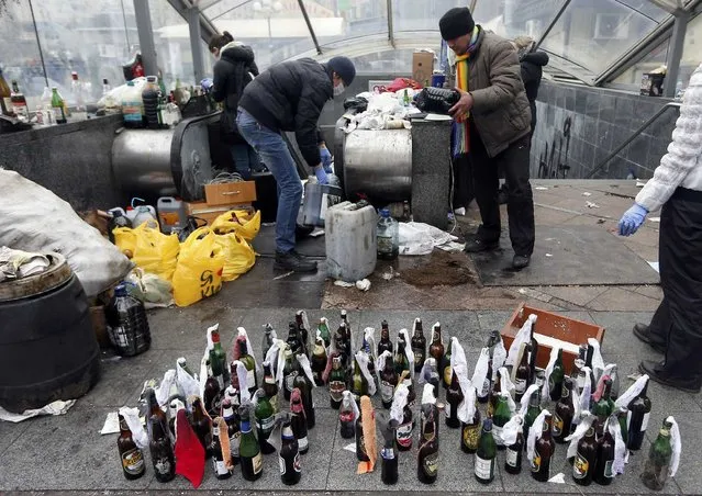 Anti-government protesters prepare Molotov cocktails during clashes with riot police in the Independence Square in Kiev February 20, 2014. (Photo by Vasily Fedosenko/Reuters)