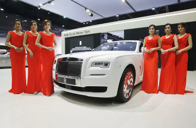 Models pose beside a Rolls-Royce KoChaMongkol Extended Wheelbase Ghost during a media presentation at the 37th Bangkok International Motor Show in Bangkok, Thailand, March 22, 2016. (Photo by Chaiwat Subprasom/Reuters)