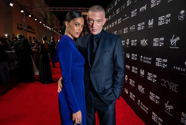 A handout picture released by the Red Sea Film Festival shows French actor Vincent Cassel and wife Tina Kunakey on the red carpet during the opening ceremony of the 4th edition of the Red Sea film festival in the Saudi city of Jeddah, on December 6, 2021. (Photo by Ammar Abd Rabbo/Red Sea Film Festival/AFP Photo)