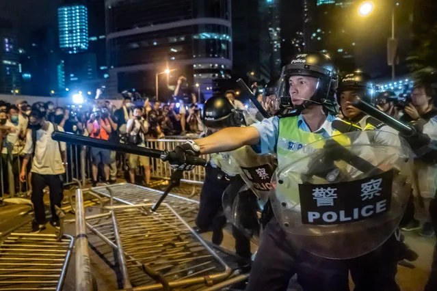 Police officers charge toward protesters after a rally against the extradition law proposal at the Central Government Complex on June 10, 2019 in Hong Kong China. Over a million protesters marched in Hong Kong on Sunday against a controversial extradition bill that would allow suspected criminals to be sent to mainland China for trial as tensions escalated in recent weeks. (Photo by Anthony Kwan/Getty Images)