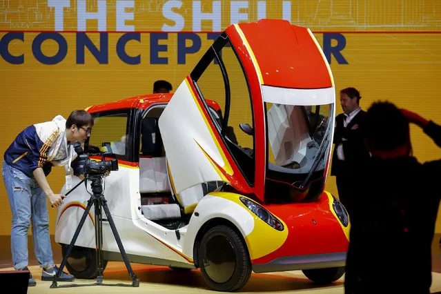 People take pictures of a high-efficiency petrol-burning concept car as it is unveiled by Royal Dutch Shell during a ceremony in Beijing, China April 22, 2016. (Photo by Damir Sagolj/Reuters)