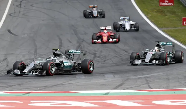 Mercedes driver Nico Rosberg of Germany, left, steers his car  in front of Mercedes driver Lewis Hamilton of Britain, during the the Formula One Grand Prix race, at the Red Bull Ring in Spielberg, southern Austria, Sunday, June 21, 2015. (AP Photo/Darko Bandic)
