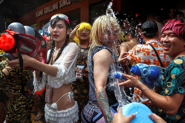 People play with water as they celebrate the Songkran holiday which marks the Thai New Year in Bangkok, Thailand, on April 13, 2024. (Photo by Chalinee Thirasupa/Reuters)