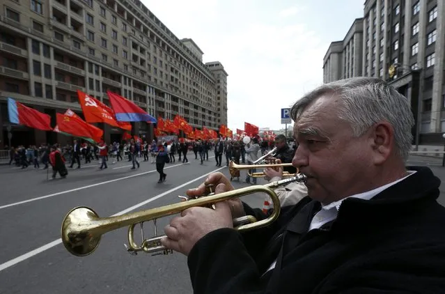 Orchestra musicians play trumpets during a May Day rally in Moscow, Russia, May 1, 2016. (Photo by Sergei Karpukhin/Reuters)