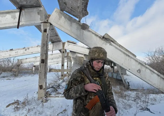 A service member of the Ukrainian armed forces is seen at combat positions near the line of separation from Russian-backed rebels in the Donetsk region, Ukraine on February 6, 2022. (Photo by Oleksandr Klymenko/Reuters)