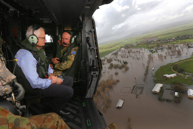 Australian Prime Minister Malcolm Turnbull looks at damaged and flooded areas from aboard an Australian Army helicopter after Cyclone Debbie passed through the area near the town of Bowen, located south of the northern Queensland town of Townsville in Australia, March 30, 2017. (Photo by Gary Ramage/Reuters)