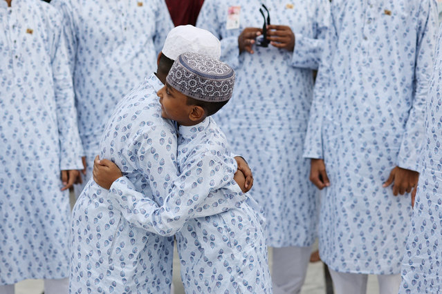 Children hug after performing the Eid al-Fitr prayer at the Baitul Mukarram National Mosque, in Dhaka, Bangladesh, on April 11, 2024. (Photo by Mohammad Ponir Hossain/Reuters)