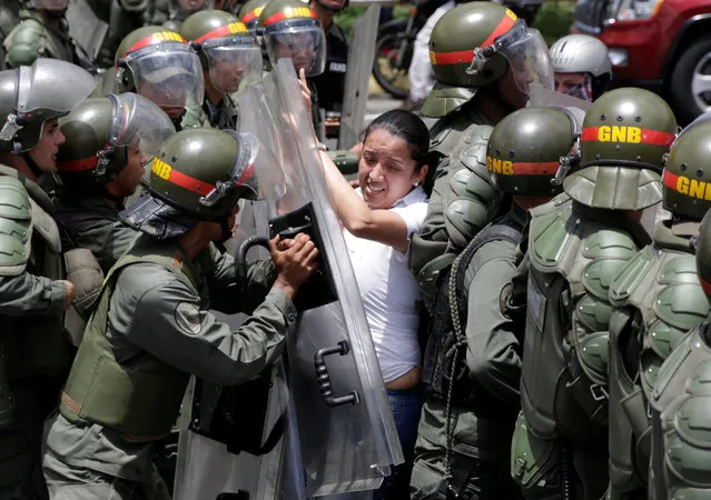 Gaby Arellano, deputy of the Venezuelan coalition of opposition parties (MUD), clashes with national guards during a rally against Venezuela's President Nicolas Maduro's government in Caracas, Venezuela April 1, 2017. (Photo by Marco Bello/Reuters)
