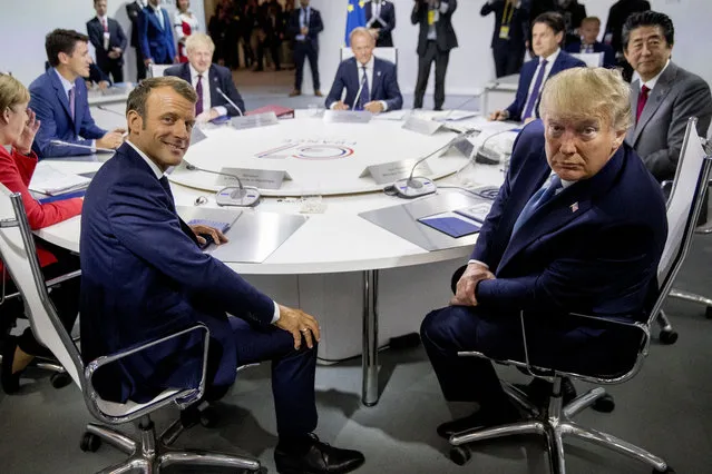 French President Emmanuel Macron, center left, and President Donald Trump, center right, participate in a G-7 Working Session on the Global Economy, Foreign Policy, and Security Affairs the G-7 summit in Biarritz, France, Sunday, August 25, 2019. Also pictured is German Chancellor Angela Merkel, left, Canadian Prime Minister Justin Trudeau, second from left, British Prime Minister Boris Johnson, third from left, President of the European Council Donald Tusk, center, Italian Prime Minister Giuseppe Conte, top second from right, and Japanese Prime Minister Shinzo Abe, right. (Photo by Andrew Harnik/AP Photo/Pool)