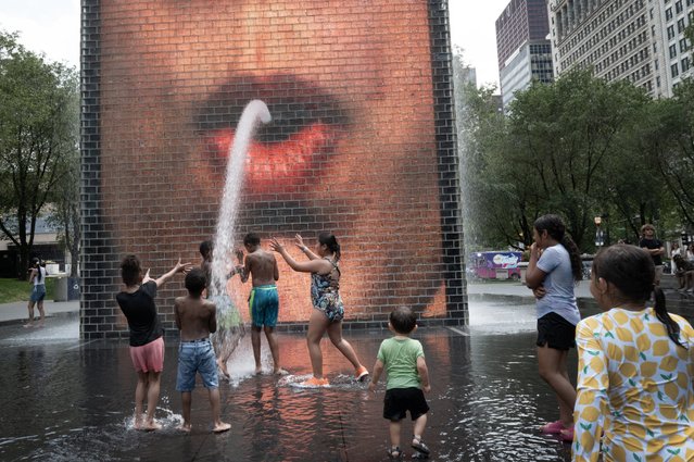 People cool off at Crown Fountain in Millennium Park as temperatures reached a record high of 97 degrees Fahrenheit on June 17, 2024 in Chicago, Illinois. Temperatures in the city are expected to reach highs in the 90s for the remainder of the week. (Photo by Scott Olson/Getty Images)