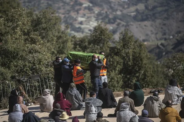 People carry the coffin of 5-year-old Rayan during his funeral after his body was retrieved from a deep well, in the village of Ighran in Morocco's Chefchaouen province, Monday, February 7, 2022. Five-year-old Rayan was pulled dead from a 32-meter (105 foot) deep dry well where he was trapped for five days. (Photo by Mosa'ab Elshamy/AP Photo)
