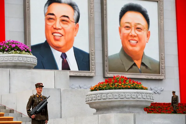 Soldiers stand under pictures of former North Korean leaders Kim Il Sung and Kim Jong Il at the capital's main ceremonial square after a mass rally and parade, a day after the ruling party wrapped up its first congress in 36 years by elevating him to party chairman, in Pyongyang, North Korea, May 10, 2016. (Photo by Damir Sagolj/Reuters)