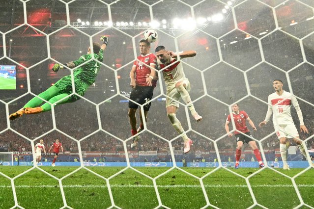 Turkey's goalkeeper #01 Mert Gunok, Austria's defender #14 Leopold Querfeld and Turkey's defender #03 Merih Demiral jump for the ball during the UEFA Euro 2024 round of 16 football match between Austria and Turkey at the Leipzig Stadium in Leipzig on July 2, 2024. (Photo by Angelos Tzortzinis/AFP Photo)