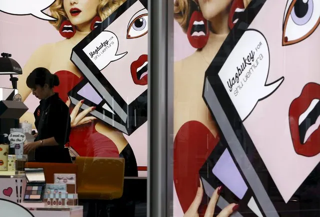 A shop clerk prepares to open a cosmetic store at Omotesando shopping district in Tokyo, Japan, April 30, 2015. (Photo by Yuya Shino/Reuters)