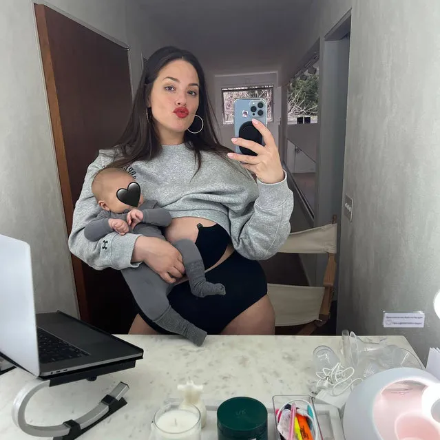 American model and television presenter Ashley Graham multitasks carrying one of her babies and kissingin the first decade of March 2022. (Photo by ashleygraham/Instagram)
