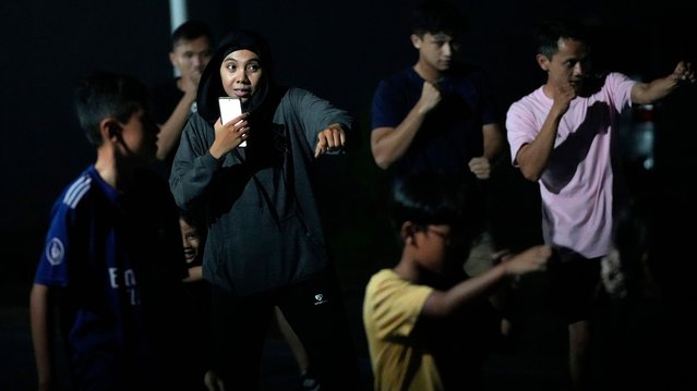 Martial arts coach Rahimatul Hasanah, center, trains youths in self defense on a public badminton court in Jakarta, Indonesia, Wednesday, July 3, 2024. (Photo by Achmad Ibrahim/AP Photo)