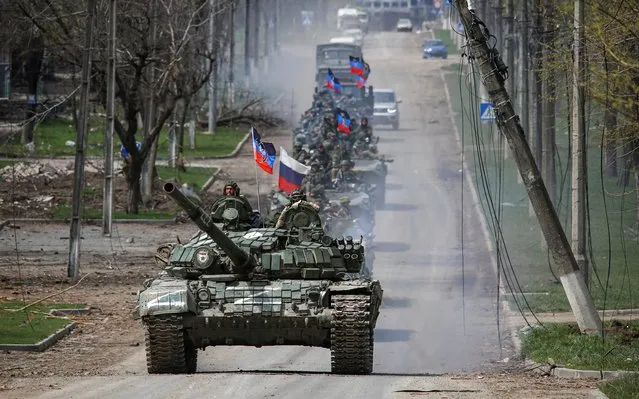An armoured convoy of pro-Russian troops moves along a road during Ukraine-Russia conflict in the southern port city of Mariupol, Ukraine on April 21, 2022. (Photo by Chingis Kondarov/Reuters)