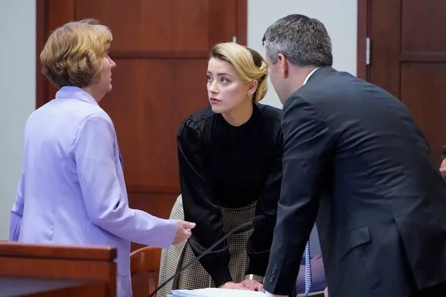 Actress Amber Heard talks to her attorneys in the courtroom at the Fairfax County Circuit Courthouse in Fairfax, Virginia, April 25, 2022. Actor Johnny Depp sued his ex-wife Amber Heard for libel in Fairfax County Circuit Court after she wrote an op-ed piece in The Washington Post in 2018 referring to herself as a “public figure representing domestic abuse”. (Photo by Steve Helber/Pool via AFP Photo)