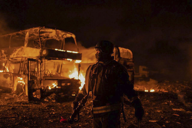 In this photo provided by the Ukrainian Emergency Situations Ministry, firefighters put out fire caused by fragments of a Russian rocket after it was shot down by air defense system during the night Russian rocket attack in Kyiv, Ukraine, early Tuesday, May 16, 2023. (Photo by Ukrainian Emergency Situations Ministry via AP Photo)