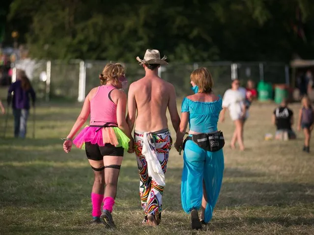 People walk through the site at Worthy Farm in Pilton on the eve of the first day of the 2014 Glastonbury Festival. (Photo by Ian Gavan/Getty Images)