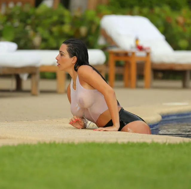 Kim Kardashian looks stunning in a see-through white tank top as she enjoys a second honeymoon in Mexico with Kanye West. The newly-weds stayed at the exclusive home of Girls Gone Wild founder Joe Francis, after jetting in to Punta Mita, to catch some pool side relaxation. The Wests honeymooned in Ireland and Prague after their May 24 wedding in Italy. (Photo by Brian Prahl/Splash News)