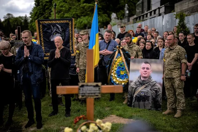 Relatives and friends attend the funeral of Melnyk Andriy, 23, a Ukrainian military servicemen who as killed in Kharkiv province, in Lviv, Ukraine, Saturday, May 14, 2022. (Photo by Emilio Morenatti/AP Photo)