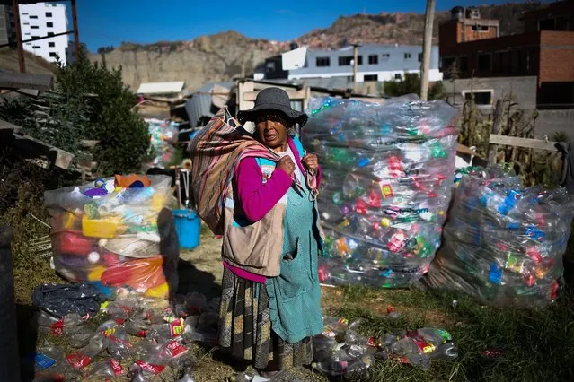 Zenobia Castillo (58), an Aymara woman recycler, loads part of the material she got from the garbage dumps into an Aguayo in La Paz, Bolivia on May 18, 2022. Every morning several people make tours of garbage containers to collect Pet Bottles, Plastics or empty containers that are then taken to their homes to be collected so that once they have enough weight, they are sold to companies that reuse these materials. It is estimated that Bolivia generates more than 7,022 tons of garbage per day and of this amount only approximately 4% is recycled when 80% could be used, Bolivia currently has a program called “Zero waste” promoted by Swisscontact that seeks to support more than 50 Bolivian women in the city of La Paz with training on the treatment of reusable containers. (Photo by Luis Gandarillas/Anadolu Agency via Getty Images)