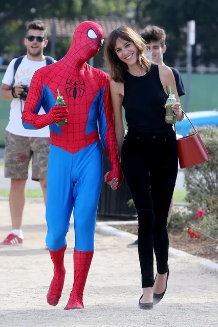 Alexa Chung steps out with a new (Spider)-Man after reported split from Alexander Skarsgard on July 19, 2017. The British model and fashion designer was spotted in Beverly Hills with the superhero, driving in a red convertible Mustang and taking a walk hand in hand. As the couple gazed affectionately at each other, they sipped on some green juice. It appeared that Alexa was filming for something as the duo was accompanied by a film crew. Alexa was seen in two different outfits for the filming. As she cruised in the convertible she was seen in an oversized check shirt with a yin and yang ring on her finger, carrying a cup of coffee. For her romantic walk, she changed into an all black outfit and carried a red bucket bag. Spider-Man was seen in his superhero outfit, at times taking off his mask and pulling his costume down to his waist. Alexa has reportedly split from Skarsgard, her beau of two years. (Photo by Splash News and Pictures)