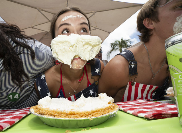 In this photo provided by the Florida Keys News Bureau, Maddie Miller, of Tampa, Fla., raises her head during the World Famous Key Lime Pie Eating Championship Tuesday, July 4, 2023, in Key West, Fla. The gooey competition, whose entrants are forbidden to use their hands, has become a subtropical alternative to Nathan's Famous Fourth of July hot dog eating contest in New York City. (Photo by Rob O'Neal/Florida Keys News Bureau via AP Photo)