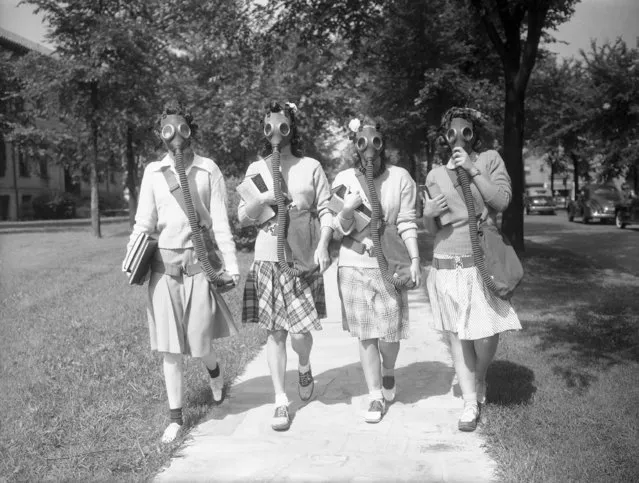 Looking ahead to the possibility that gas masks may some day be a necessary part of their ensemble, these University of Detroit students are trying out masks in a practice drill on the campus June 23, 1942. Hidden behind the masks, which they soon learned to wear with a minimum of discomfort, are, from left: Mary Turner, Helen Williams, Evelyn Buss and Joan Joliet. (Photo by AP Photo)