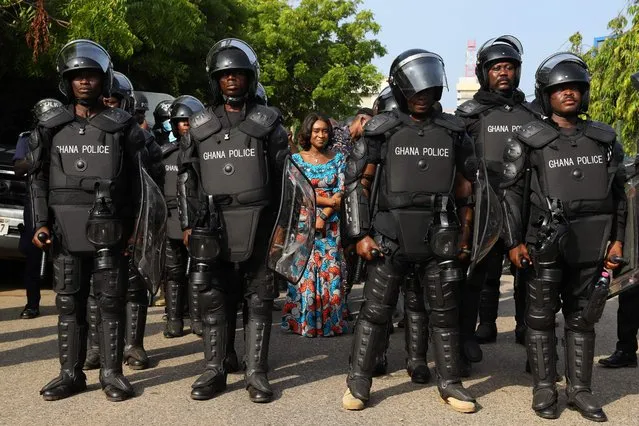 Abena Osei Asare, Deputy Minister of Finance, is protected by the police at the Ministry of Finance on the second day of a demonstration over soaring living costs in Accra, Ghana, on June 29, 2022. The West African nation, reeling from a pandemic-spurred economic slump and hammered by the impact of Russia's war in Ukraine, has seen inflation surge to more than 27 percent this month – the highest level in almost two decades. (Photo by Nipah Dennis/AFP Photo)