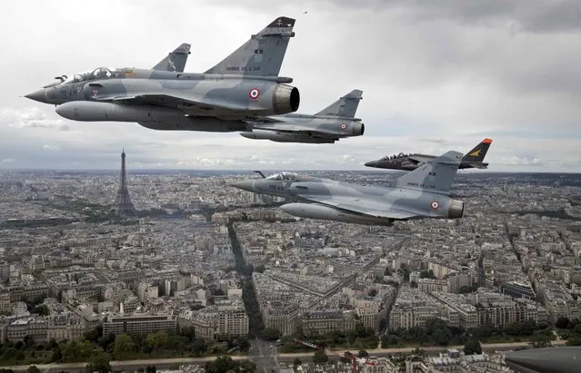 Four Mirage 2000C and one Alpha jet flight over Paris, France, on their way to participate in the Bastille Day military parade, July 14 2016. (Photo by Philippe Wojazer/Reuters)